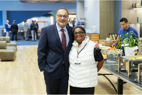 Program Director and a summit attendee posing for a photo.